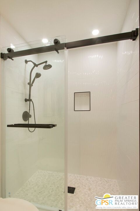 1100 East Amado Road, Unit 13C1 Palm Springs, CA 92262 - Photo 16 of 36 a bathroom with a shower