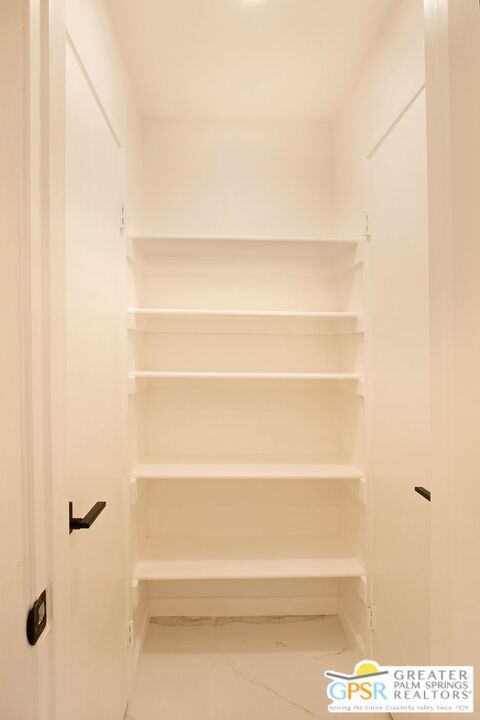 1100 East Amado Road, Unit 13C1 Palm Springs, CA 92262 - Photo 18 of 36 a view of a closet with shelves