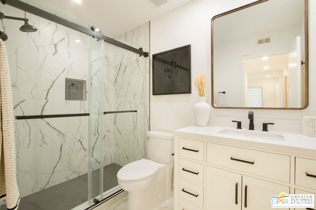 1100 East Amado Road, Unit 13C1 Palm Springs, CA 92262 - Photo 26 of 36 a bathroom with a sink a toilet and shower