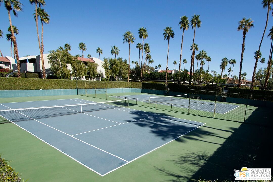 1100 East Amado Road, Unit 13C1 Palm Springs, CA 92262 - Photo 34 of 36 a view of a tennis court