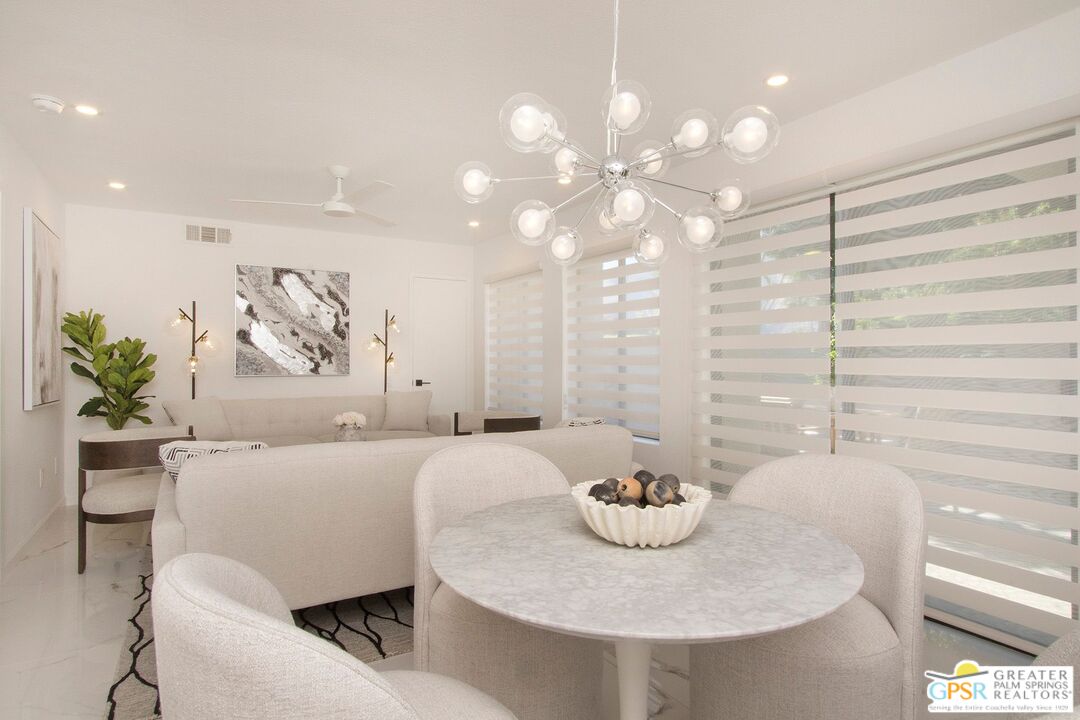 1100 East Amado Road, Unit 13C1 Palm Springs, CA 92262 - Photo 5 of 36 a living room with furniture and a chandelier