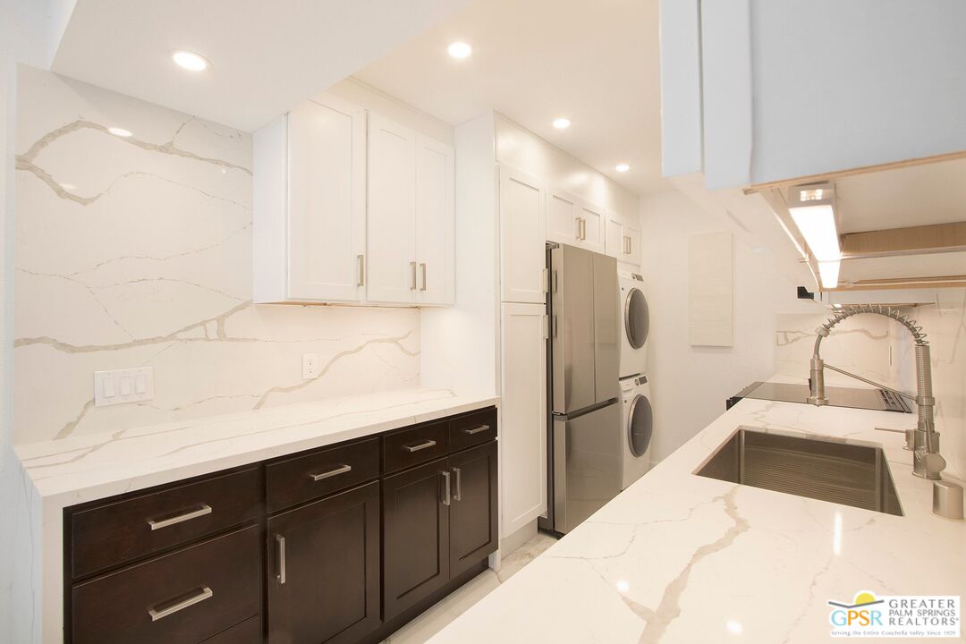 1100 East Amado Road, Unit 13C1 Palm Springs, CA 92262 - Photo 7 of 36 a kitchen with a sink stainless steel appliances and cabinets