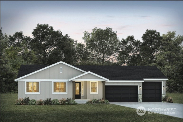 a front view of a house with a garden and yard