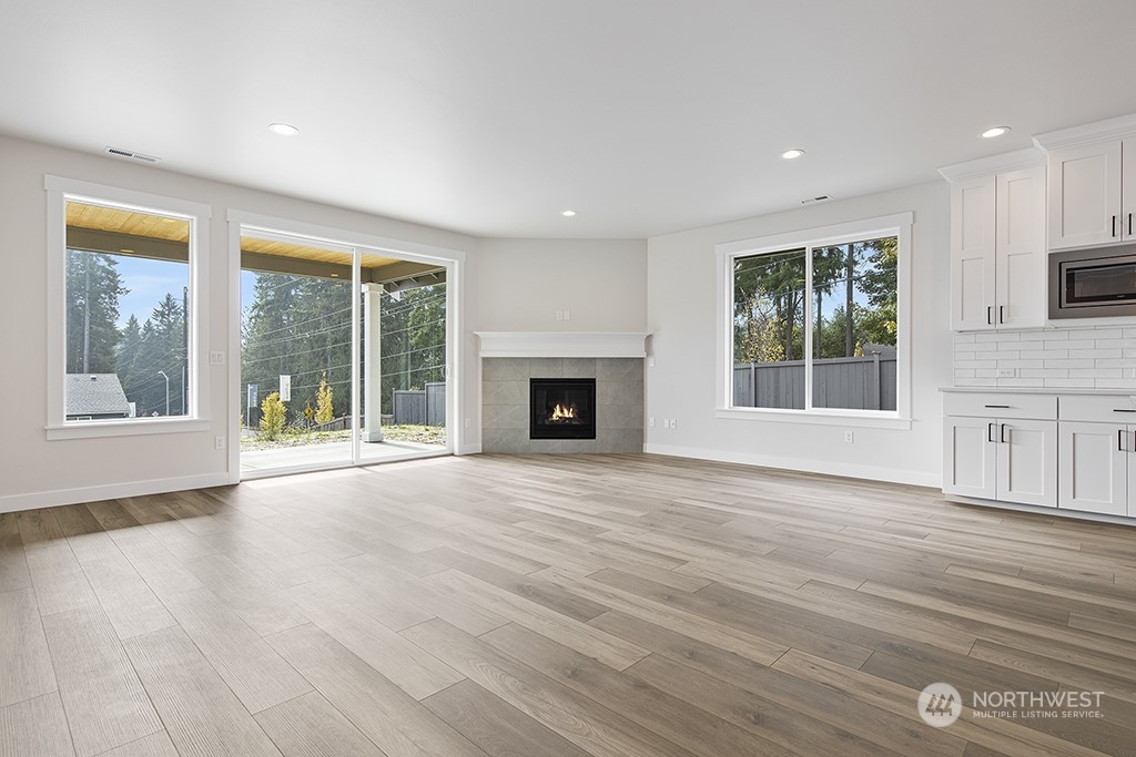 1036 Okerlund Drive Enumclaw, WA 98022 - Photo 13 of 23 a view of an empty room with wooden floor and a window