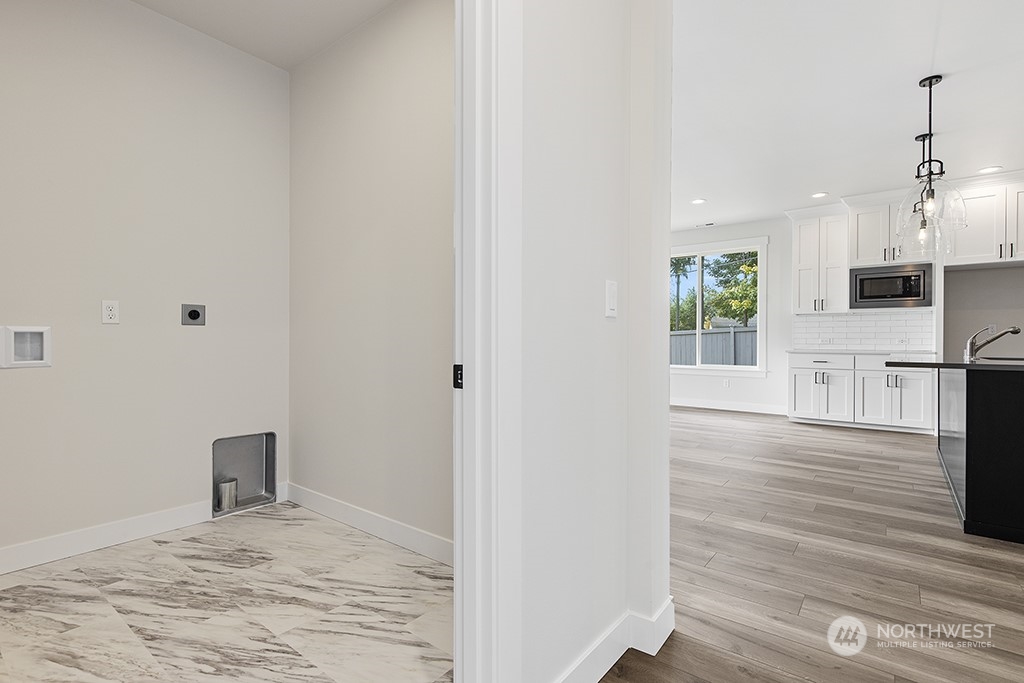 1036 Okerlund Drive Enumclaw, WA 98022 - Photo 16 of 23 a view of a kitchen with wooden floor and a window