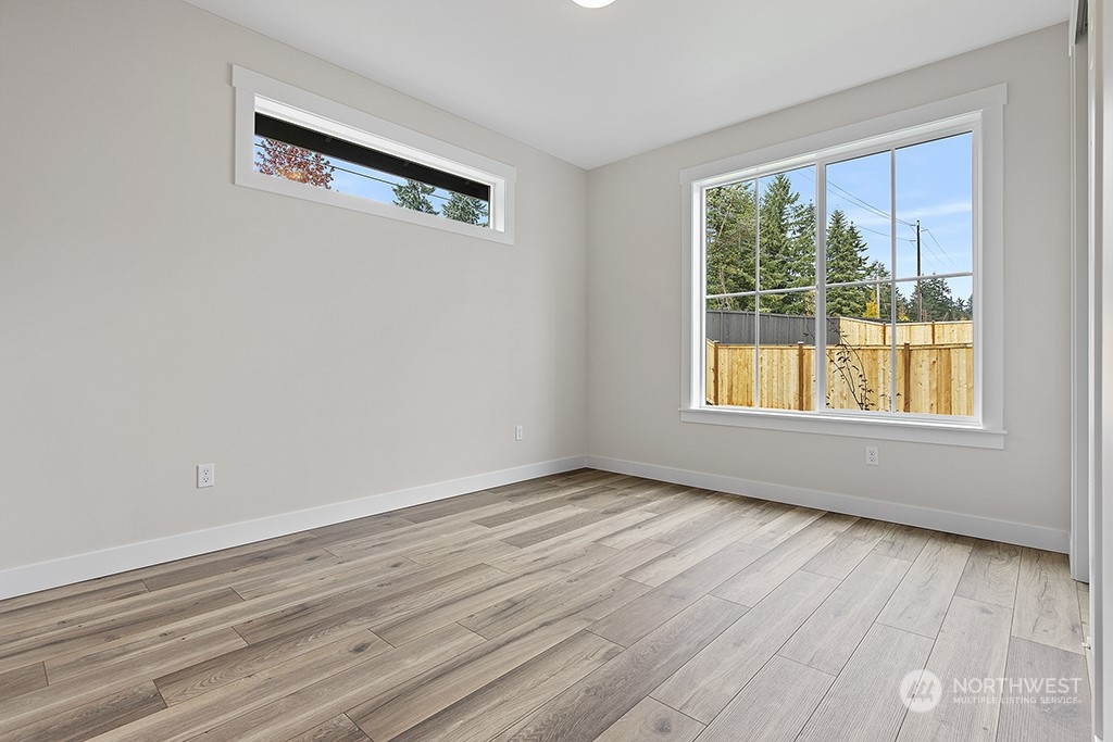 1036 Okerlund Drive Enumclaw, WA 98022 - Photo 19 of 23 a view of an empty room with wooden floor and a window