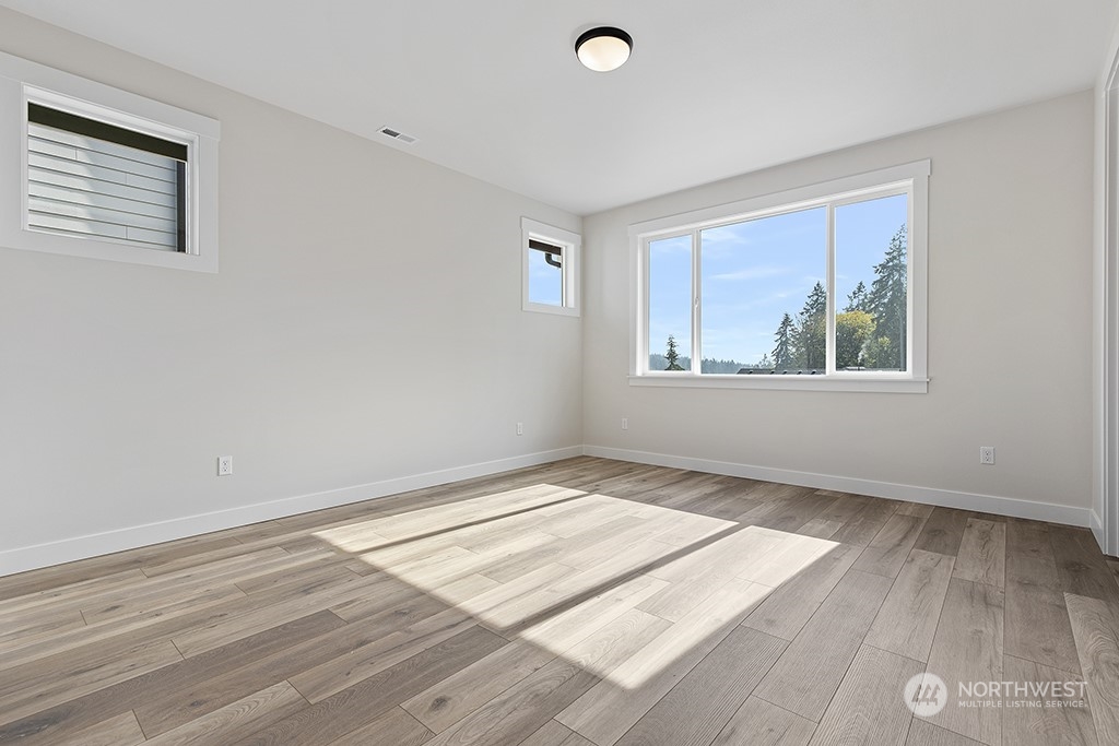 1036 Okerlund Drive Enumclaw, WA 98022 - Photo 23 of 23 an empty room with wooden floor and windows