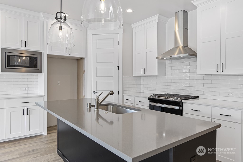 1036 Okerlund Drive Enumclaw, WA 98022 - Photo 4 of 23 a kitchen with stainless steel appliances a stove a sink and white cabinets