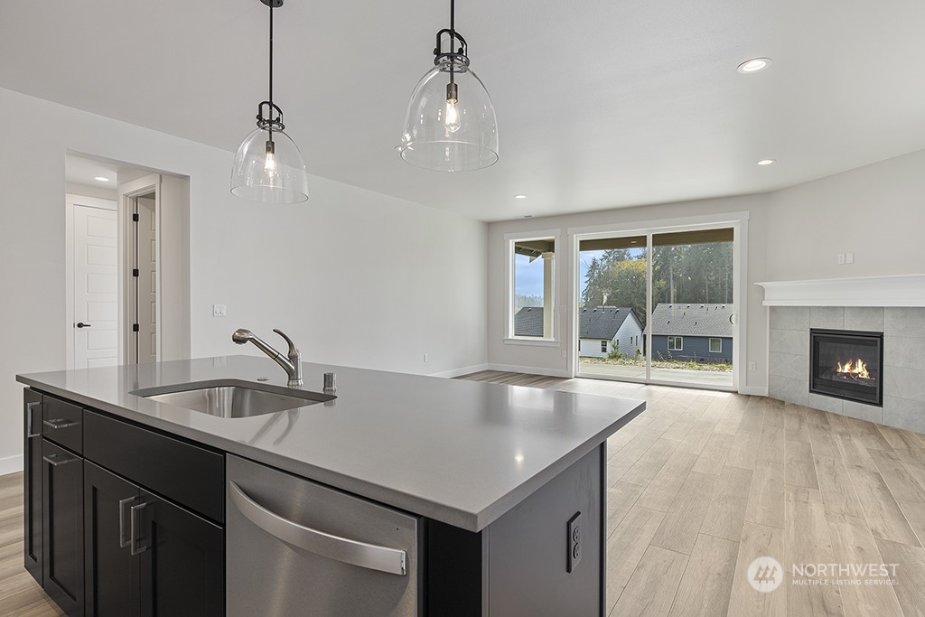 1036 Okerlund Drive Enumclaw, WA 98022 - Photo 6 of 23 a kitchen with sink cabinets and chandelier