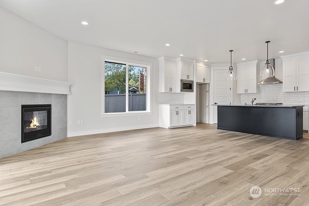 1036 Okerlund Drive Enumclaw, WA 98022 - Photo 10 of 23 a view of an empty room with a kitchen and a window