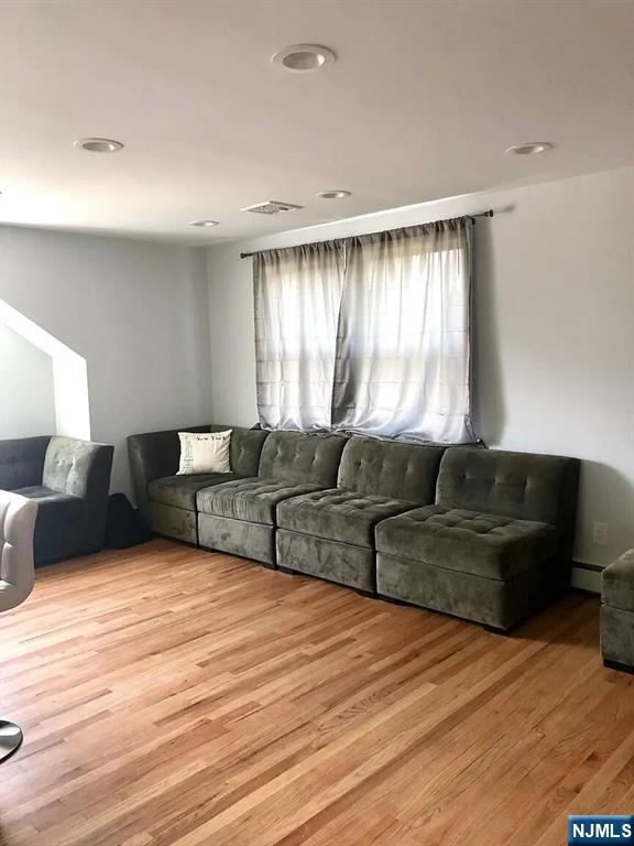 7-09 Dewey Place, Unit 1 Fair Lawn, NJ 07410 - Photo 5 of 7 a living room with furniture and a large window