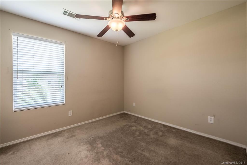 667 Potter Place Road, Unit 104 Fort Mill, SC 29708 - Photo 14 of 22 an empty room with a window and a fan