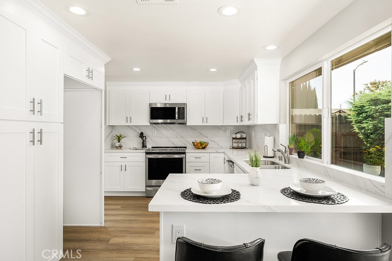 14331 Fernbrook Drive Tustin, CA 92780 - Photo 15 of 35 a kitchen with appliances a sink and cabinets