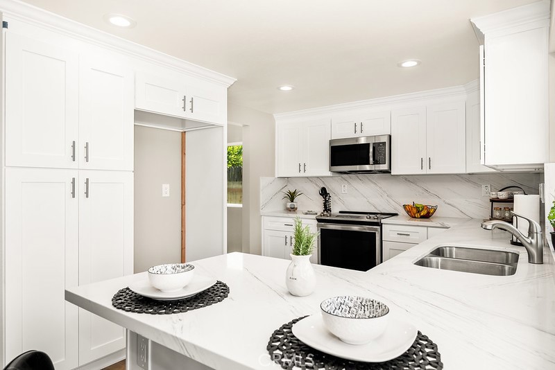 14331 Fernbrook Drive Tustin, CA 92780 - Photo 17 of 35 a kitchen with a sink stove and refrigerator