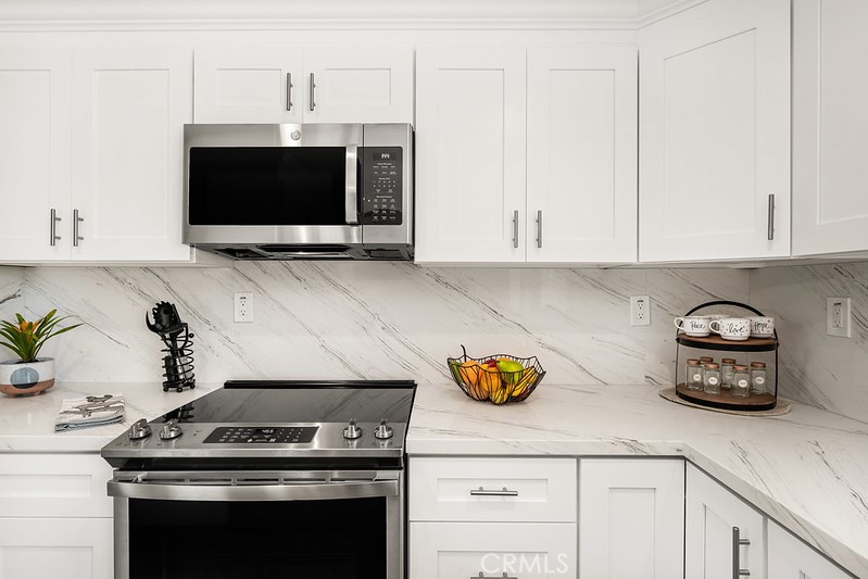 14331 Fernbrook Drive Tustin, CA 92780 - Photo 18 of 35 a kitchen with a stove and a microwave