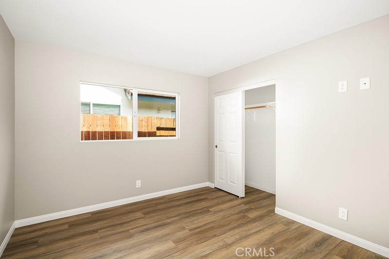 14331 Fernbrook Drive Tustin, CA 92780 - Photo 27 of 35 a view of an empty room with wooden floor and a window