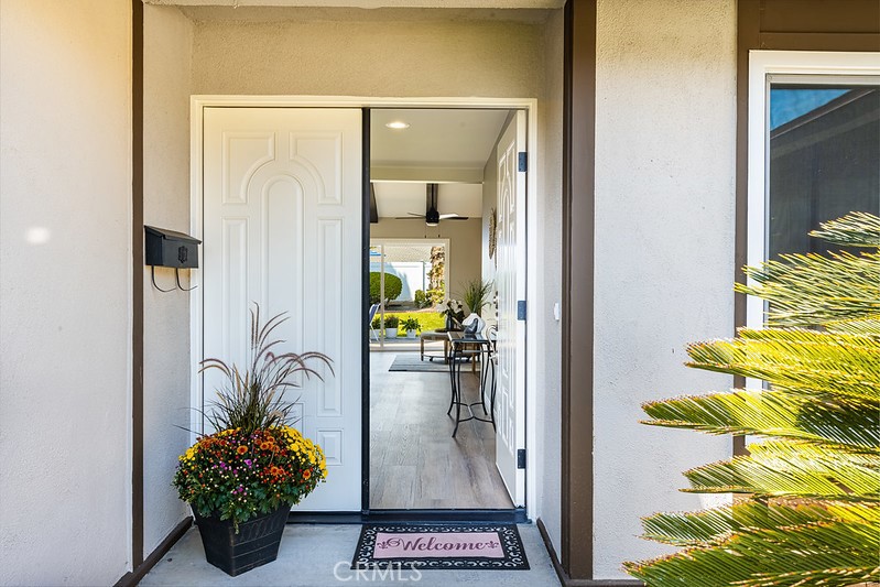 14331 Fernbrook Drive Tustin, CA 92780 - Photo 5 of 35 a view of a hallway with wooden floor and a potted plant