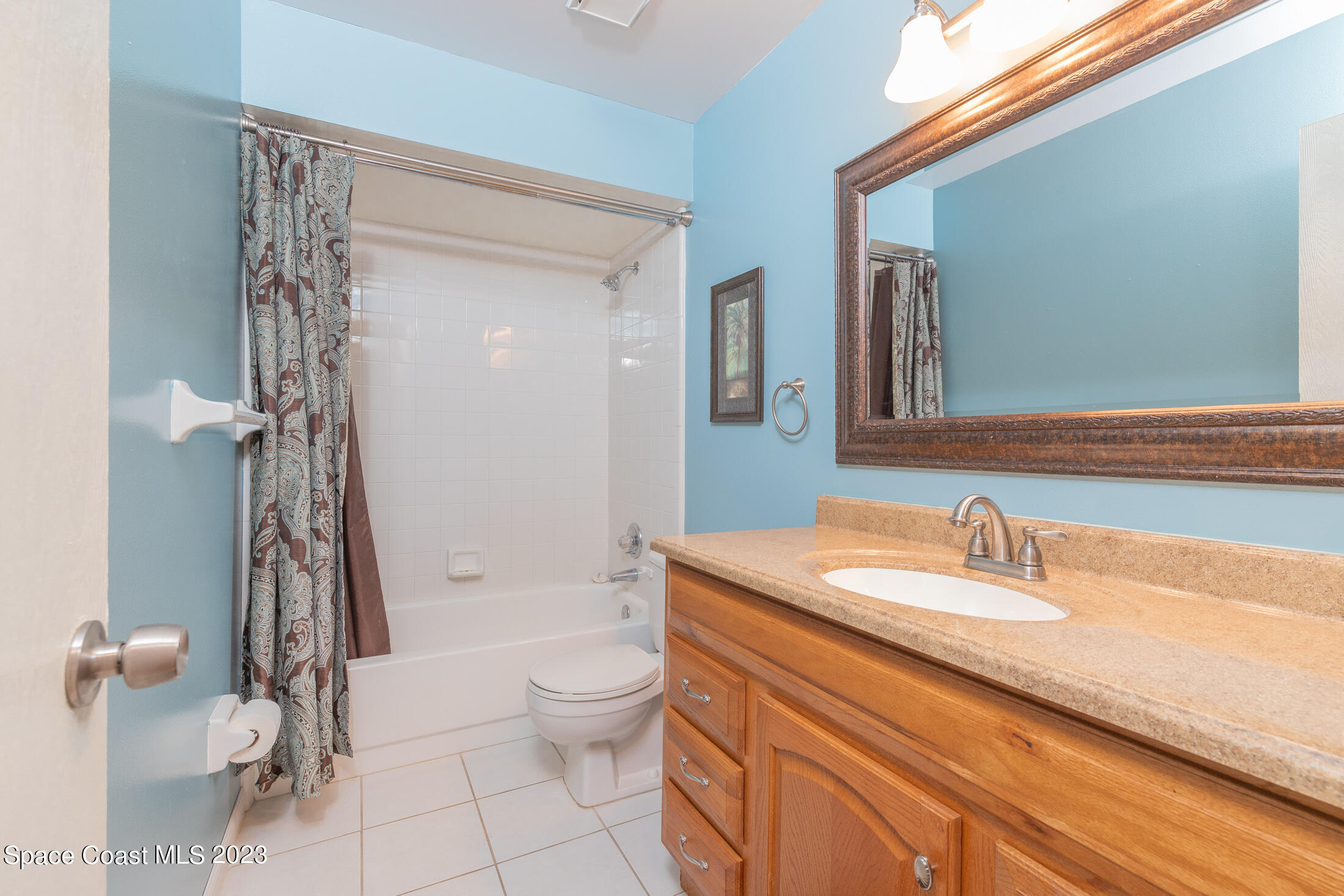 978 Locust Avenue Palm Bay, FL 32907 - Photo 11 of 41 a bathroom with a granite countertop sink toilet and shower