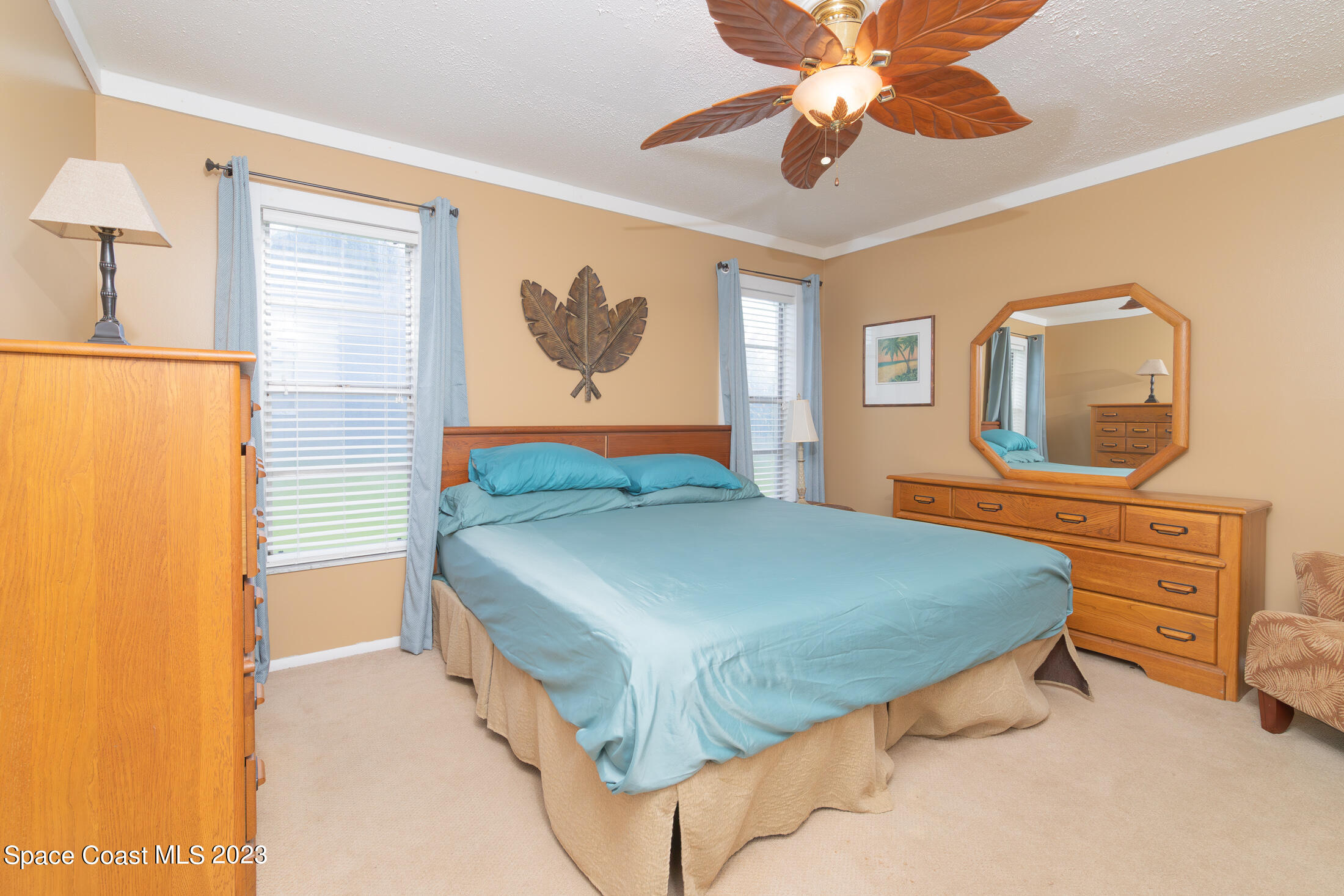 978 Locust Avenue Palm Bay, FL 32907 - Photo 12 of 41 a bedroom with a bed and a dresser