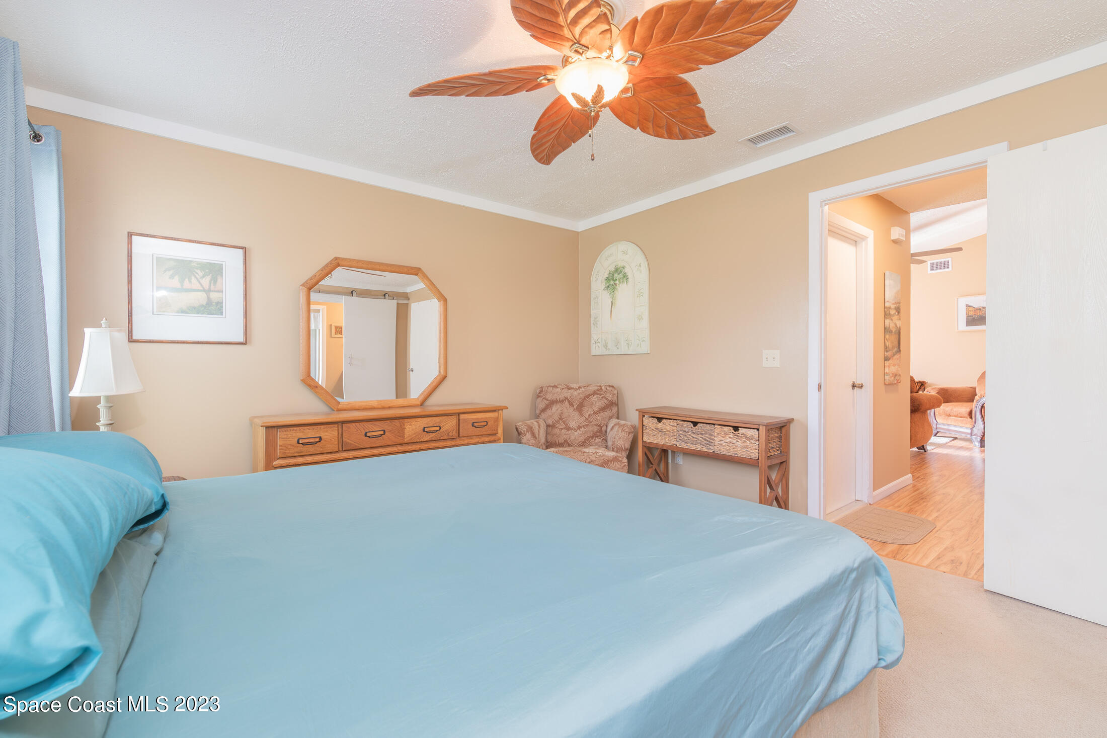 978 Locust Avenue Palm Bay, FL 32907 - Photo 13 of 41 a bedroom with a large bed and a chandelier