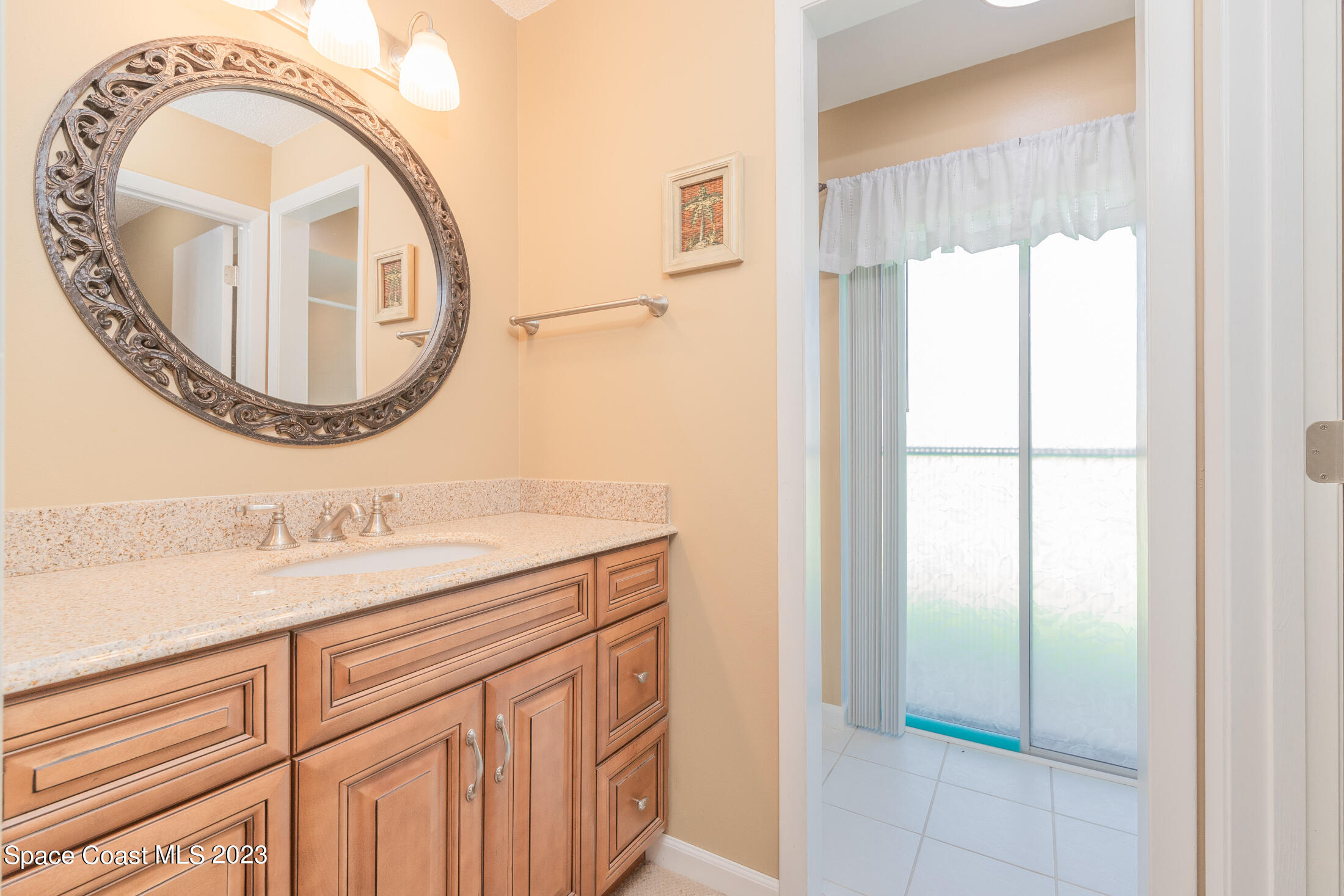 978 Locust Avenue Palm Bay, FL 32907 - Photo 14 of 41 a bathroom with a sink and a mirror