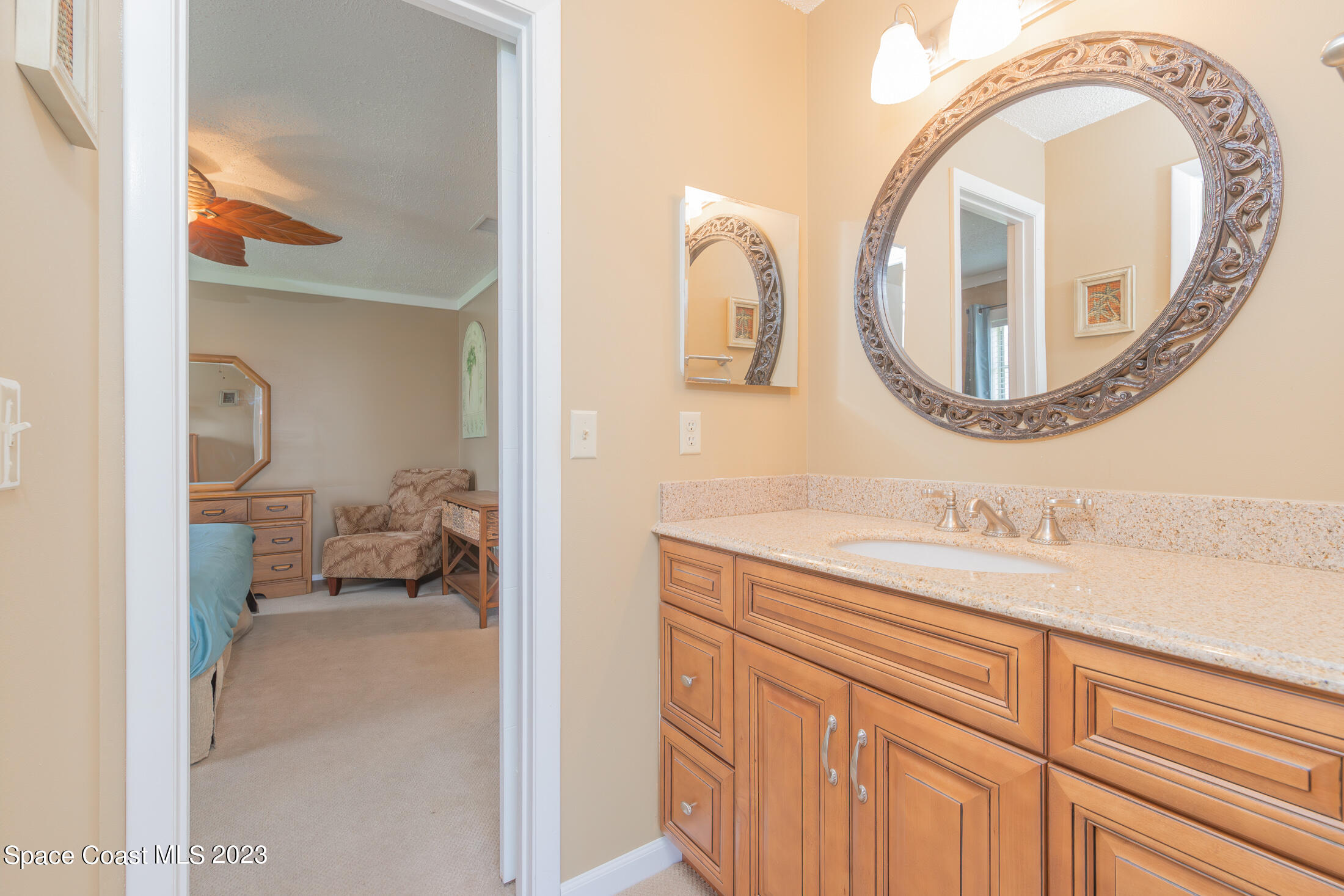 978 Locust Avenue Palm Bay, FL 32907 - Photo 16 of 41 a bathroom with a granite countertop sink and mirror