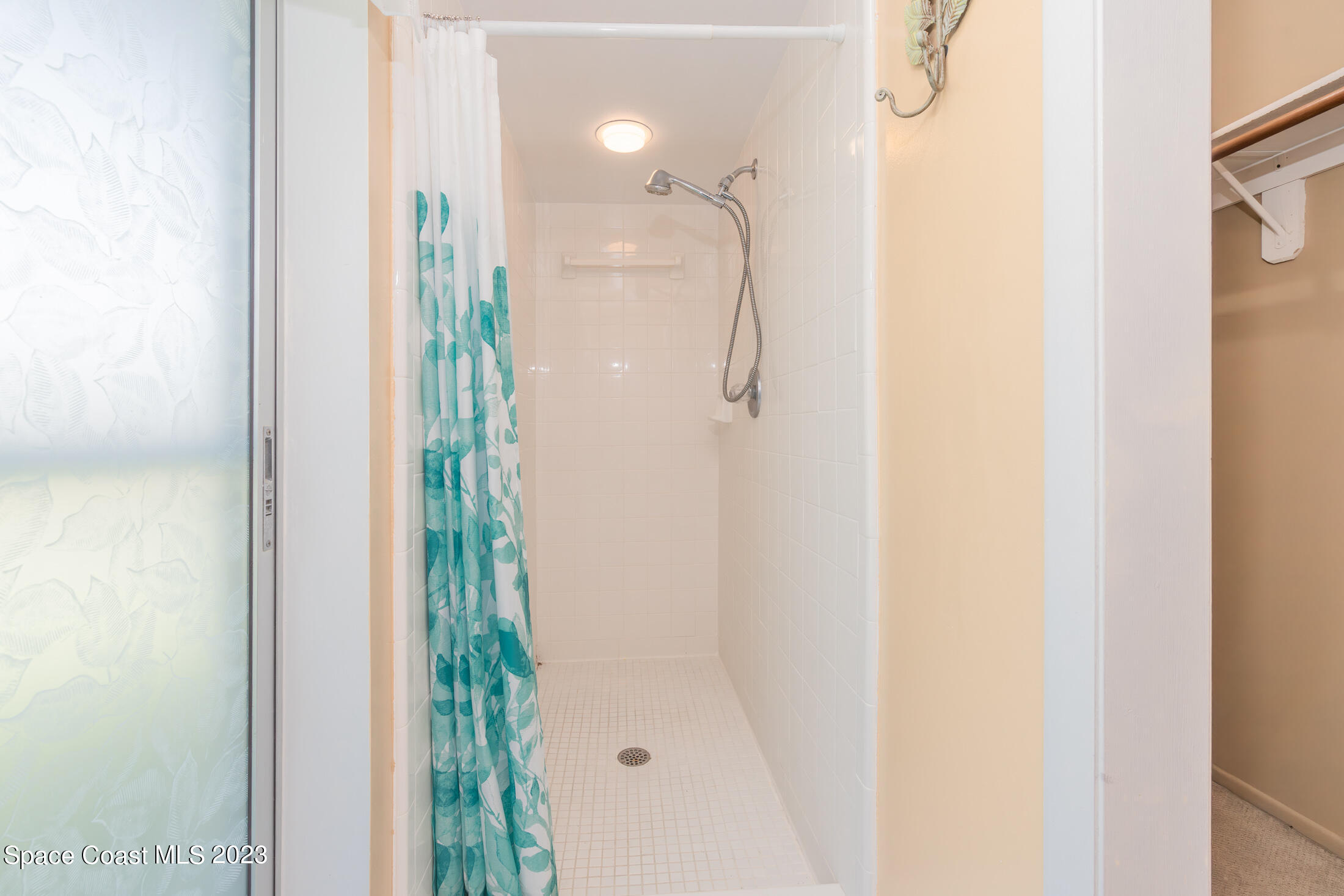 978 Locust Avenue Palm Bay, FL 32907 - Photo 17 of 41 a bathroom with a glass shower door