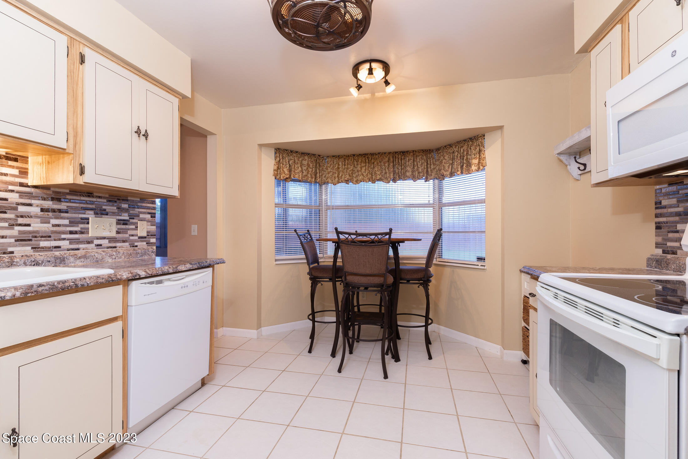 978 Locust Avenue Palm Bay, FL 32907 - Photo 20 of 41 a kitchen with a sink cabinets and window