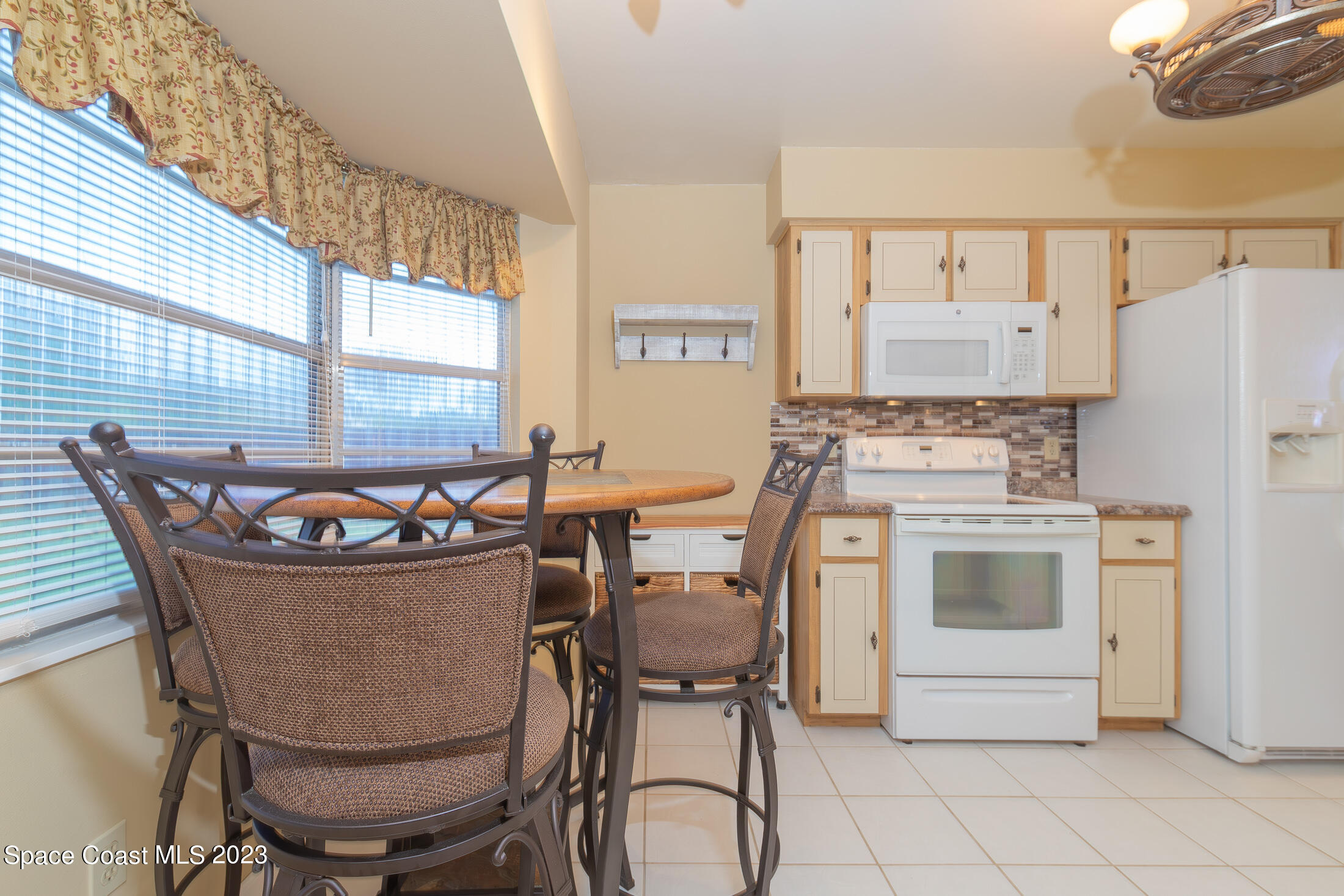 978 Locust Avenue Palm Bay, FL 32907 - Photo 22 of 41 a view of a dining room with furniture and window