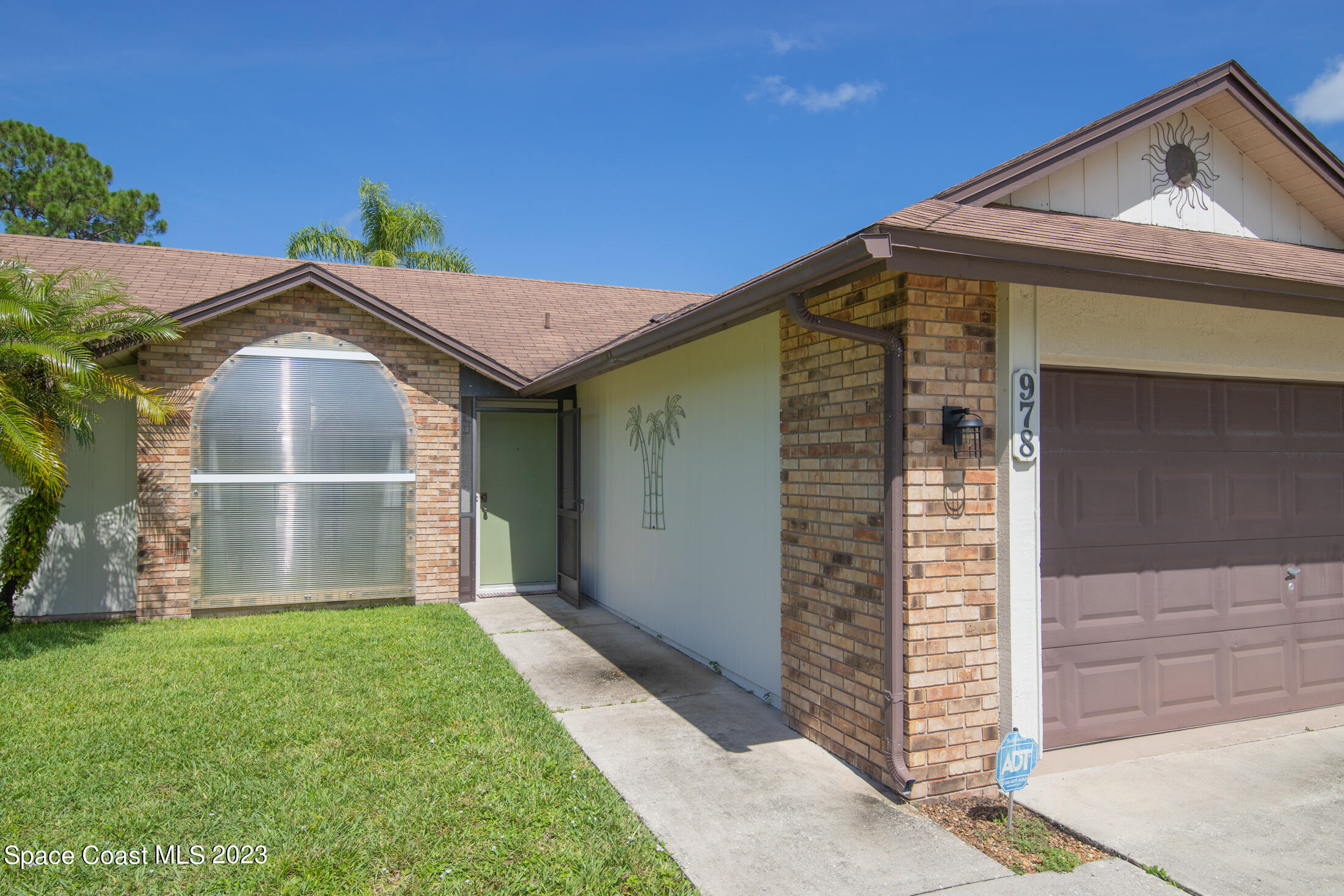 978 Locust Avenue Palm Bay, FL 32907 - Photo 26 of 41 a front view of a house with a yard and garage