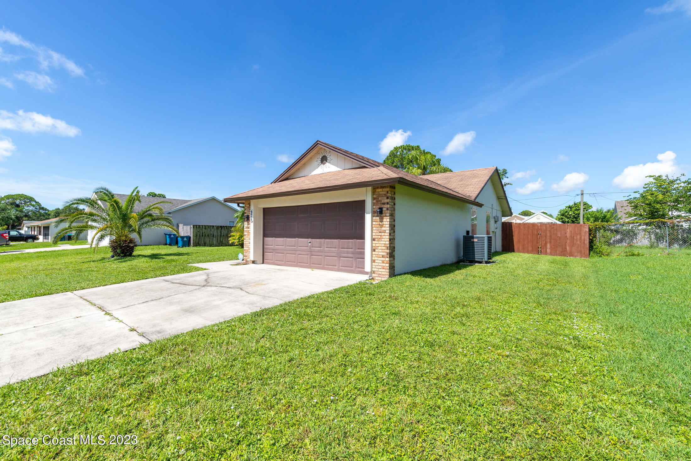 978 Locust Avenue Palm Bay, FL 32907 - Photo 27 of 41 a front view of a house with a yard and garage