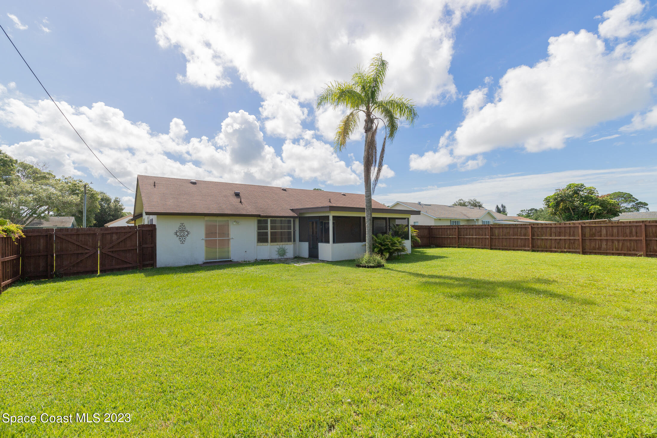 978 Locust Avenue Palm Bay, FL 32907 - Photo 28 of 41 a view of a house with pool and a yard