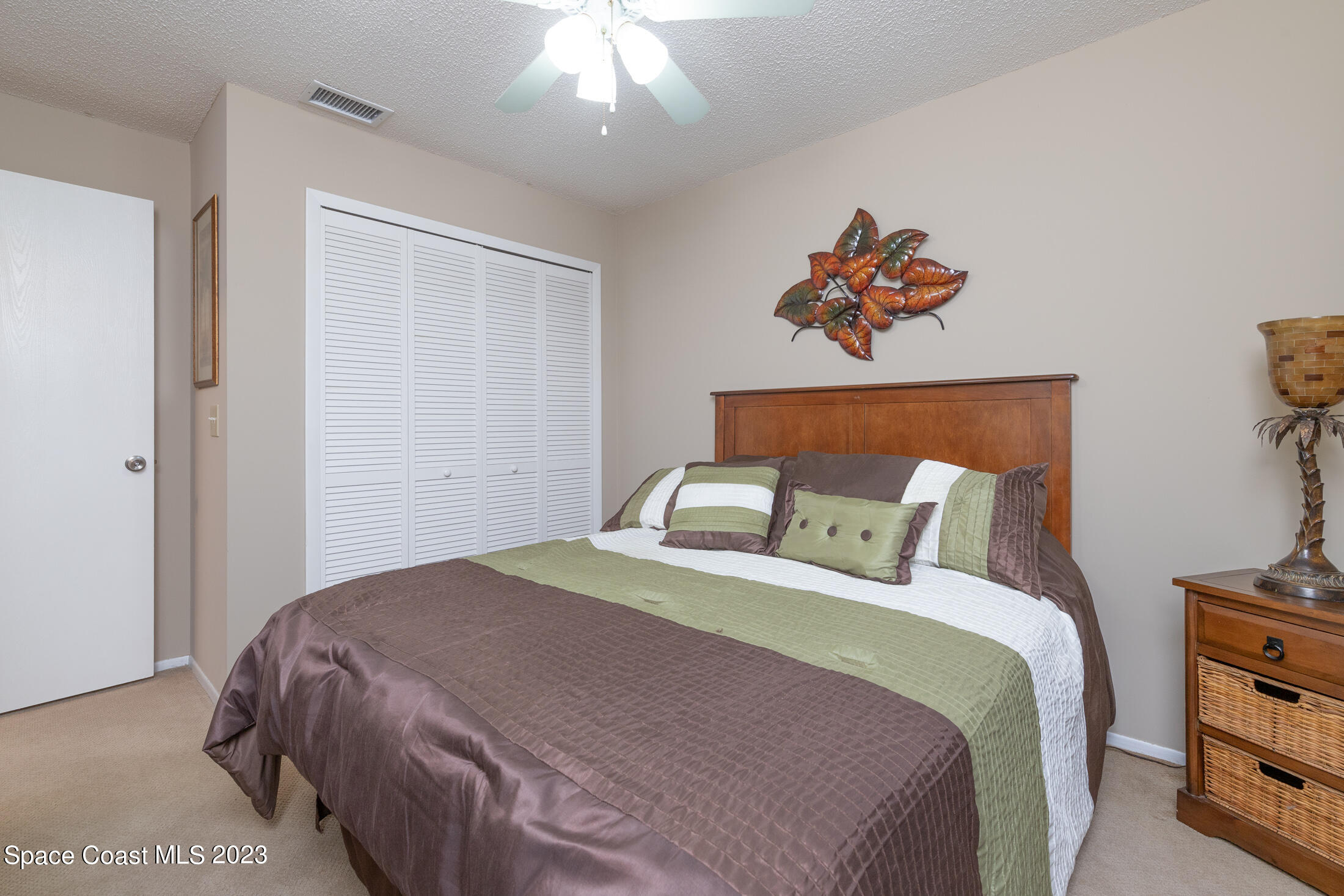 978 Locust Avenue Palm Bay, FL 32907 - Photo 7 of 41 a bedroom with a bed and a painting on the wall
