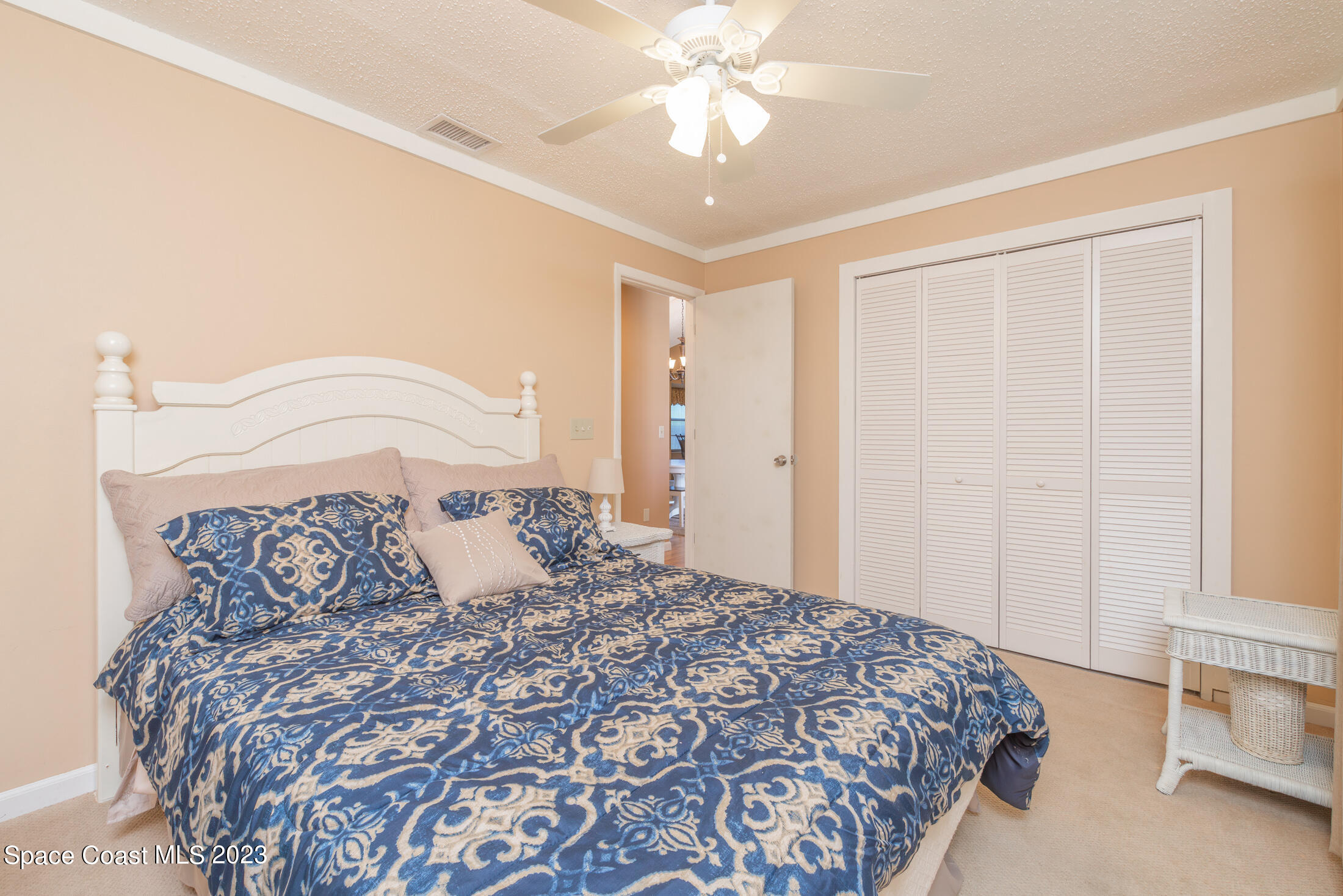 978 Locust Avenue Palm Bay, FL 32907 - Photo 9 of 41 a bedroom with a large bed and a chandelier