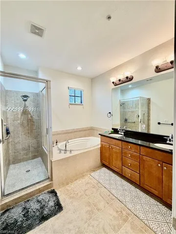 a large bathroom with a large tub shower and sink