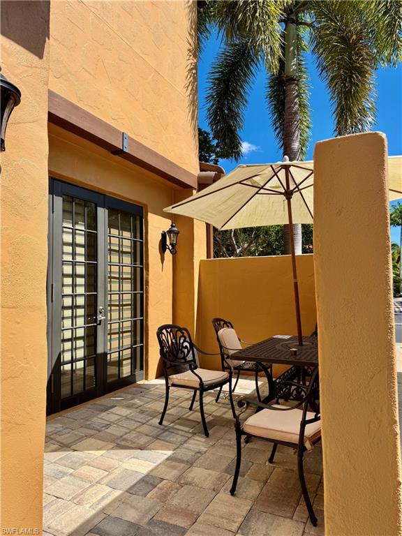 9109 Yuba Lane, Unit 80 Naples, FL 34113 - Photo 15 of 15 a view of a chairs and table in the patio