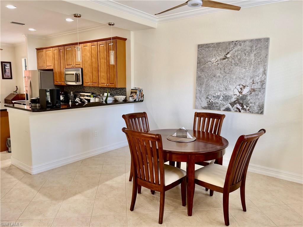 9109 Yuba Lane, Unit 80 Naples, FL 34113 - Photo 2 of 15 a view of a dining room with furniture and window