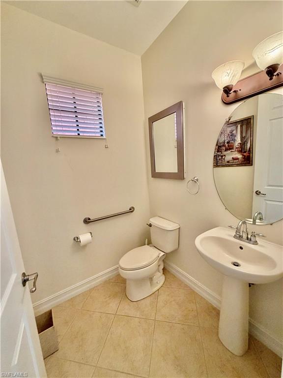 9109 Yuba Lane, Unit 80 Naples, FL 34113 - Photo 6 of 15 a bathroom with a sink a toilet and mirror