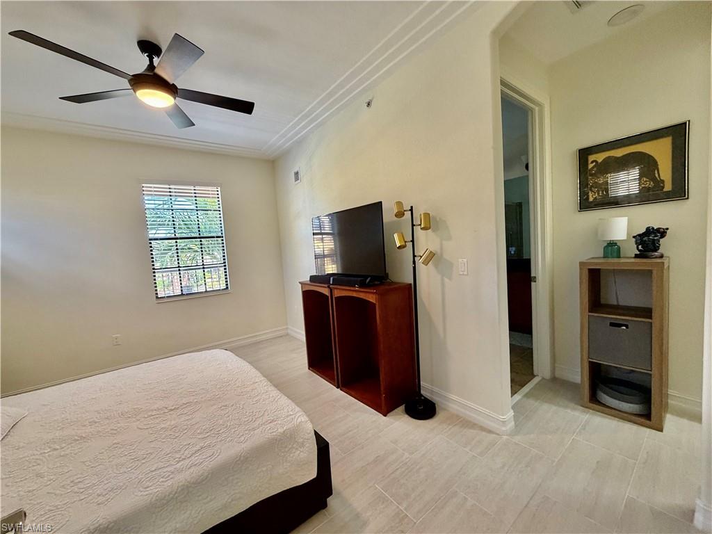 9109 Yuba Lane, Unit 80 Naples, FL 34113 - Photo 10 of 15 a bedroom with a bed and a television