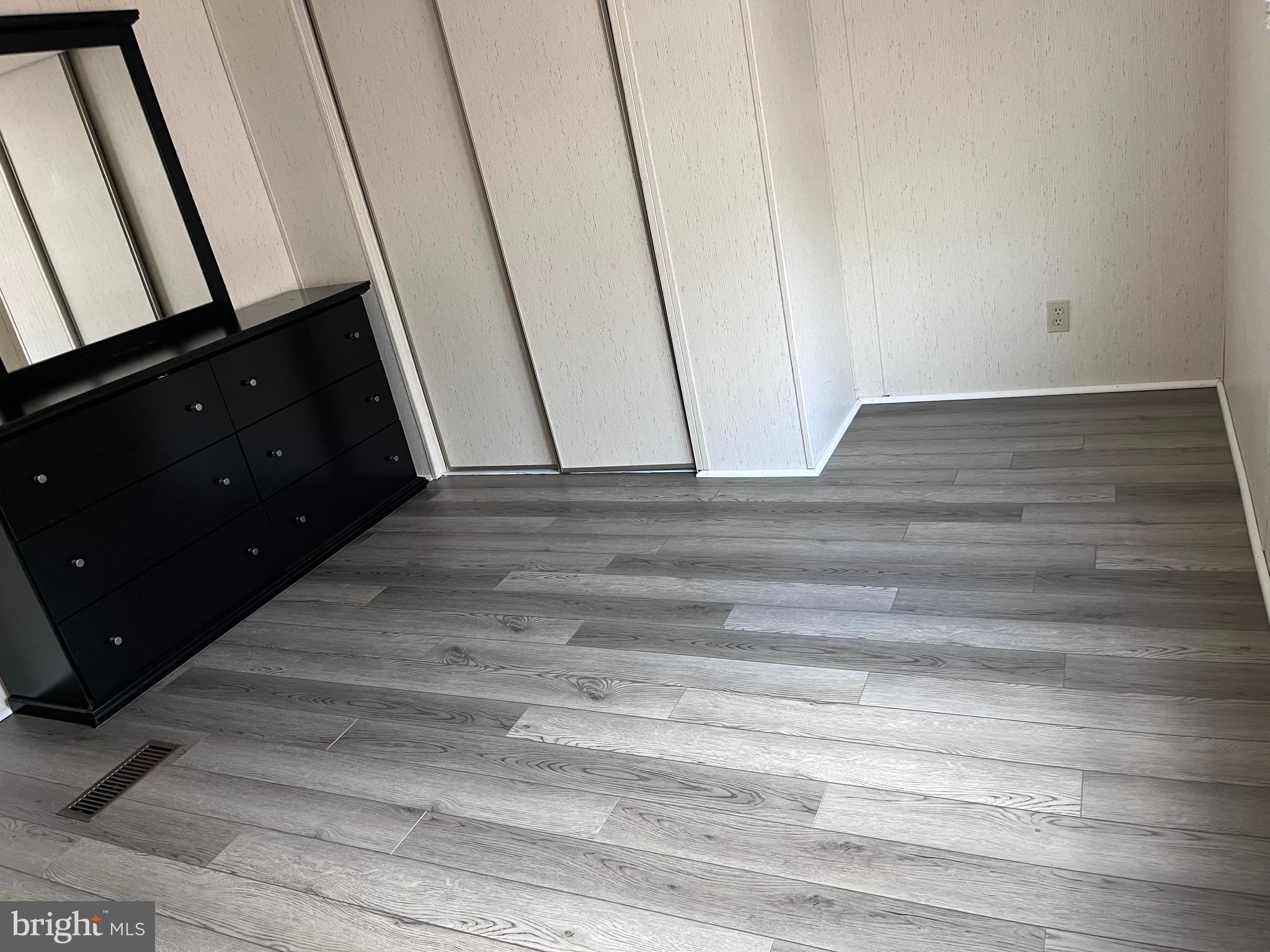 8 Merganser Road Georgetown, DE 19947 - Photo 4 of 13 a view of a closet area with hardwood floor