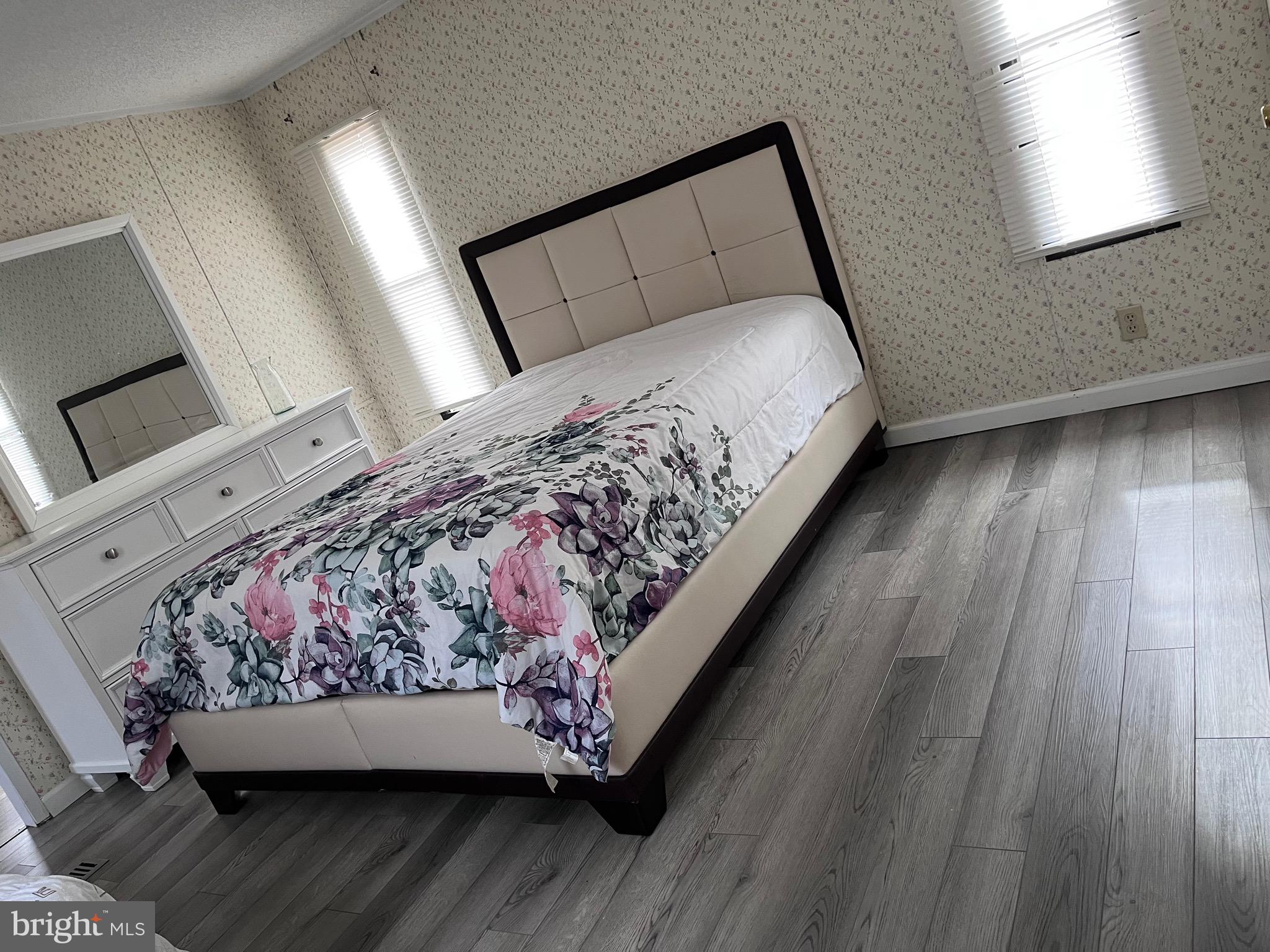 8 Merganser Road Georgetown, DE 19947 - Photo 5 of 13 a bed sitting in a bedroom next to a window with a wooden floor