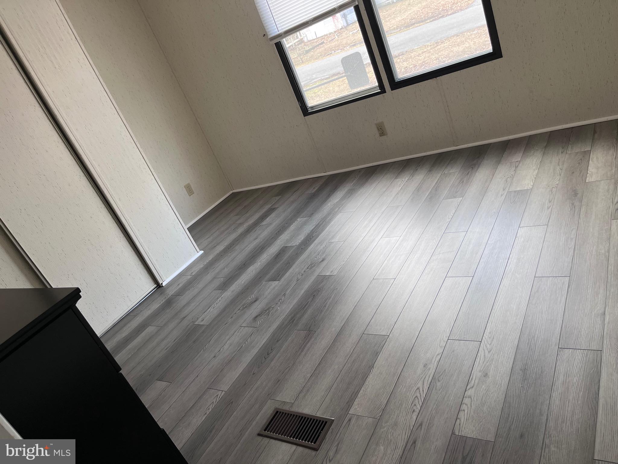 8 Merganser Road Georgetown, DE 19947 - Photo 7 of 13 a view of an empty room with wooden floor and a window