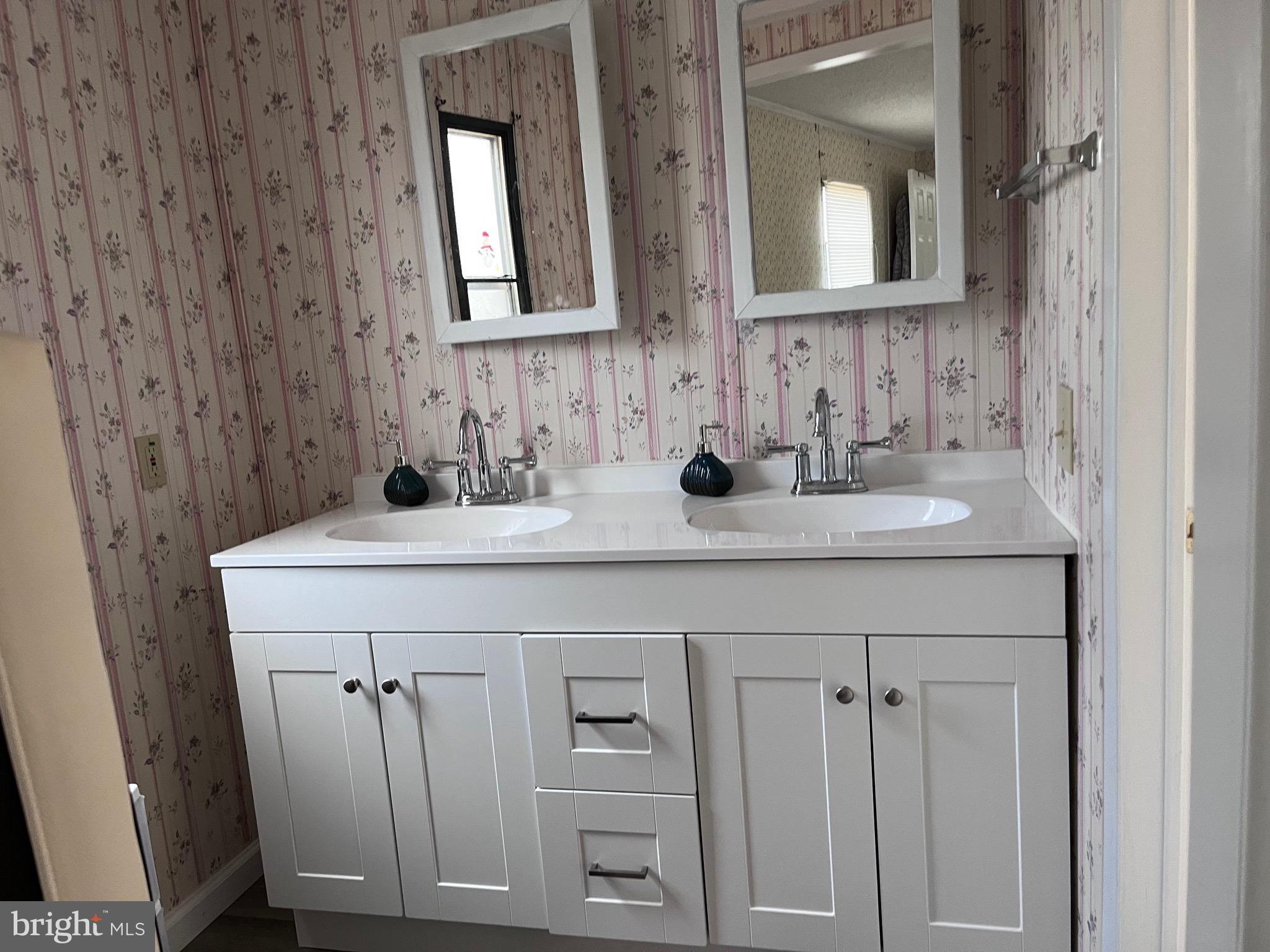 8 Merganser Road Georgetown, DE 19947 - Photo 8 of 13 a bathroom with a sink and a mirror