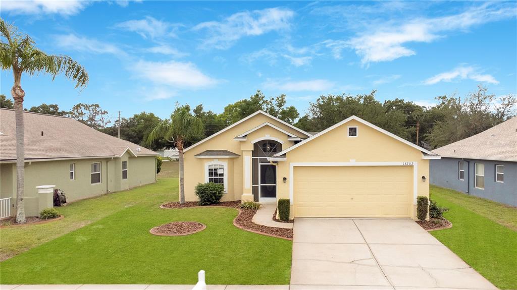 13202 Golf Ridge Place Hudson, FL 34669 - Photo 1 of 1 a view of a house with a yard