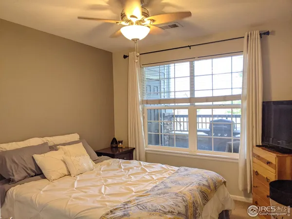 a bedroom with a large bed and a tv