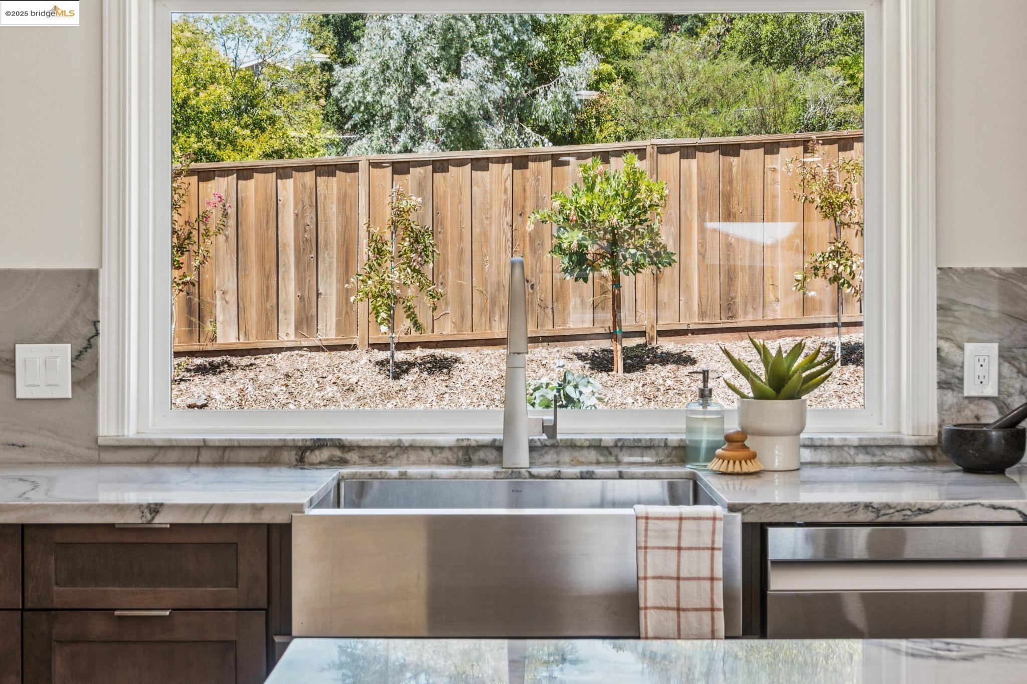 9 Yarmouth Court Oakland, CA 94619 - Photo 13 of 54 Kitchen featuring stainless steel dishwasher and light stone countertops