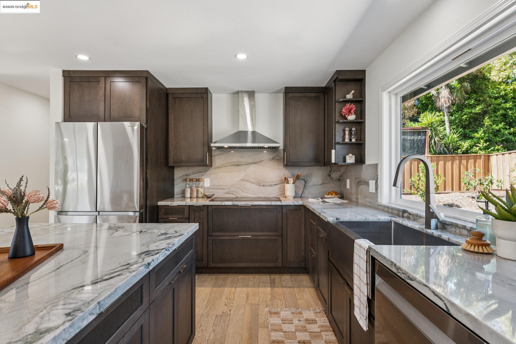 9 Yarmouth Court Oakland, CA 94619 - Photo 14 of 54 Kitchen featuring dark brown cabinets, open shelves, light stone countertops, light wood-style flooring, and recessed lighting