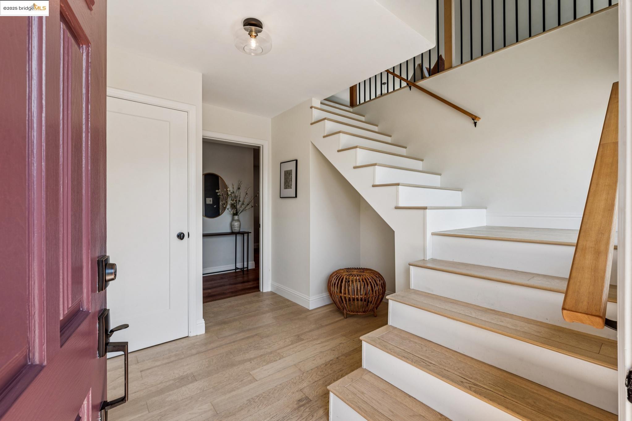 9 Yarmouth Court Oakland, CA 94619 - Photo 4 of 54 Entryway featuring light wood-type flooring and stairway