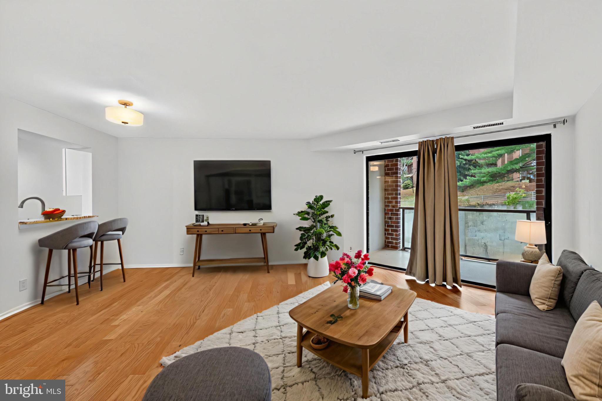 2100 Langston Boulevard, Unit 339 Arlington, VA 22201 - Photo 1 of 21 a living room with furniture and a flat screen tv