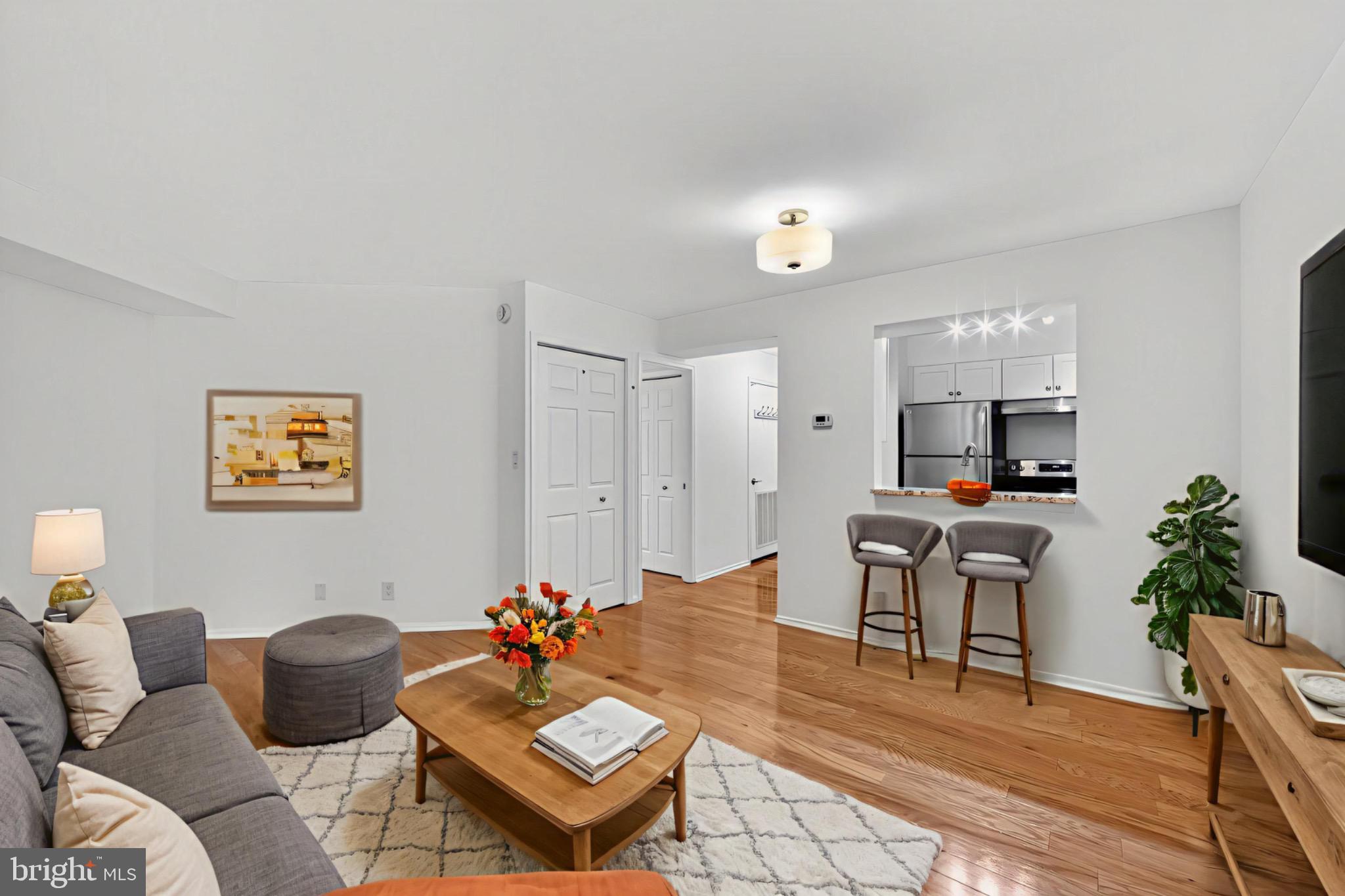 2100 Langston Boulevard, Unit 339 Arlington, VA 22201 - Photo 5 of 21 a living room with furniture and a flat screen tv